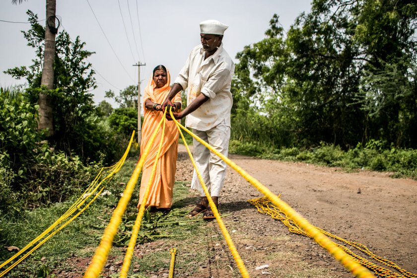 The Bhore family – Devu (wearing cap), Nandubai  and Amit  – craft ropes for farmers. There’s been no work now for weeks 

