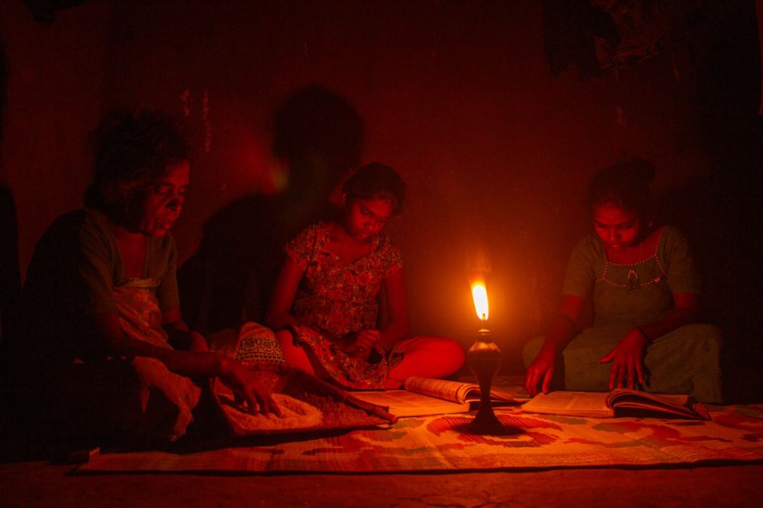 Right : The soft glow of the kerosene lamp helps my sister Kumari and my niece Ramya study, while our amma makes rice