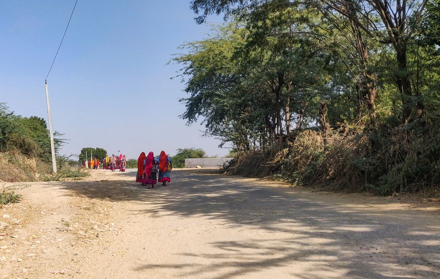 Right: Sita Devi walks towards the NREGA site with the other women in her hamlet