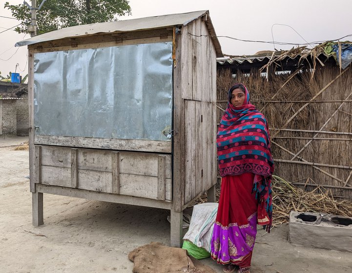 She stands next to small shop she was given by the Bihar government as part of a poverty alleviation scheme