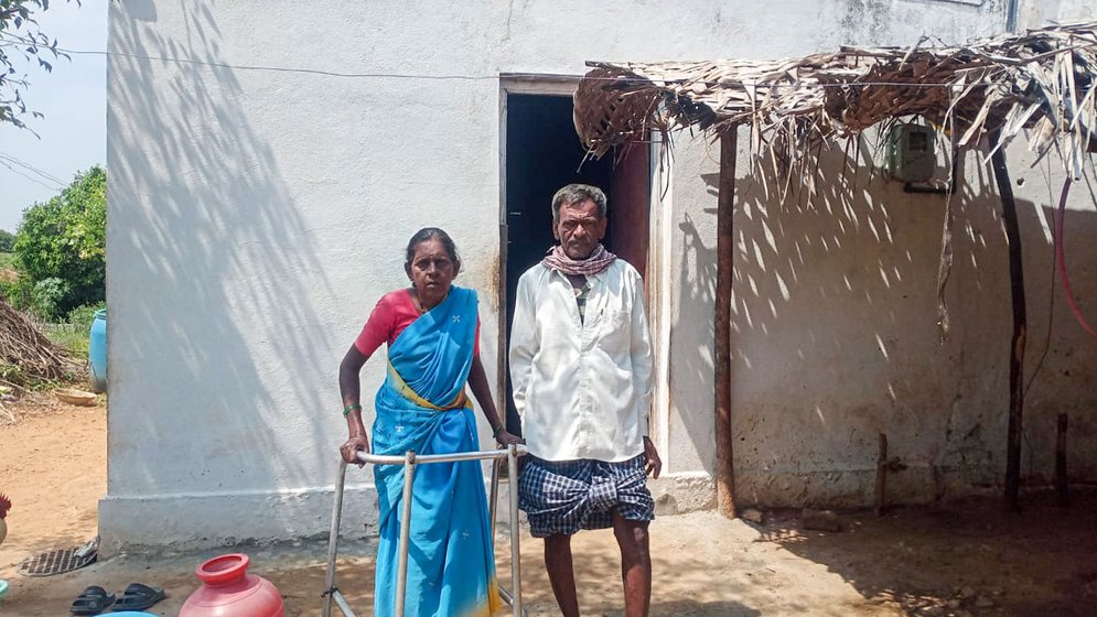Right: Mahadevamma stands with the support of a walker along with Subbaiah in front of the single-room house they share with their two children