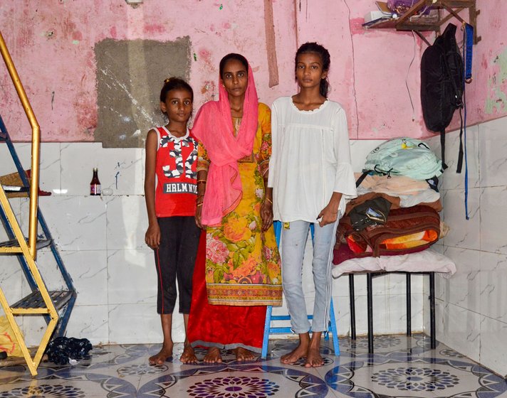 Along with online school, Roshni Khan continues to work at a cake shop to support her family, including her mother Ruksana and sister Sumaira (right)