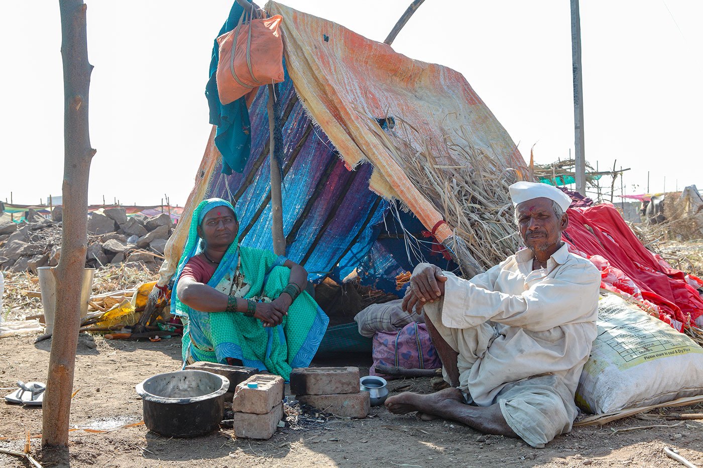 Lakshmi and her husband Paramaeshwar sitting outside her tent