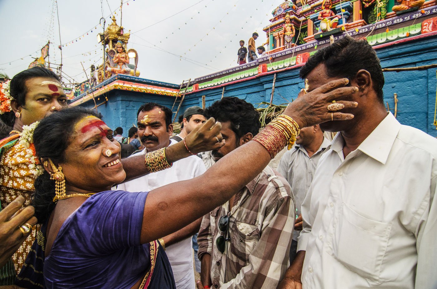 Despite the social ostracism that transgender women face, people also regard them as ‘lucky’. They gather outside the Koothandavar temple to receive blessings from aravanis.