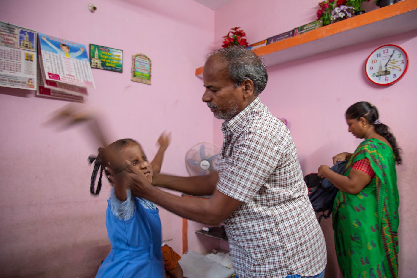 Balaraman is helping his granddaughter get ready for school. Saranya's parents are her only support system