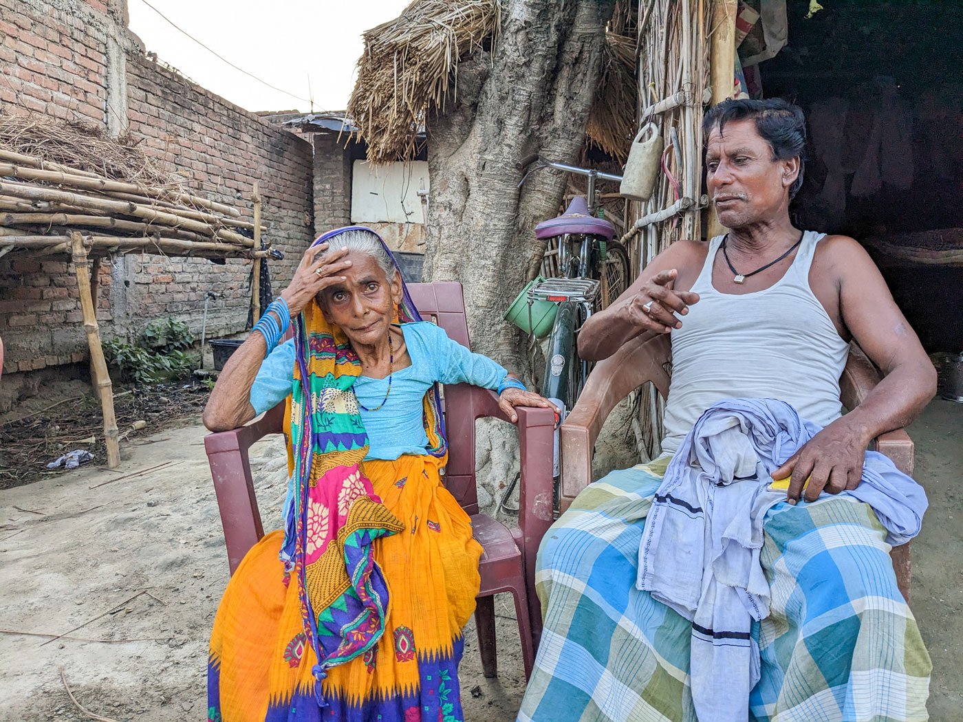 Khalifa and his 55-year-old wife, Momina, in front of their hut. Momina used to work as a tattoo artist in nearby villages