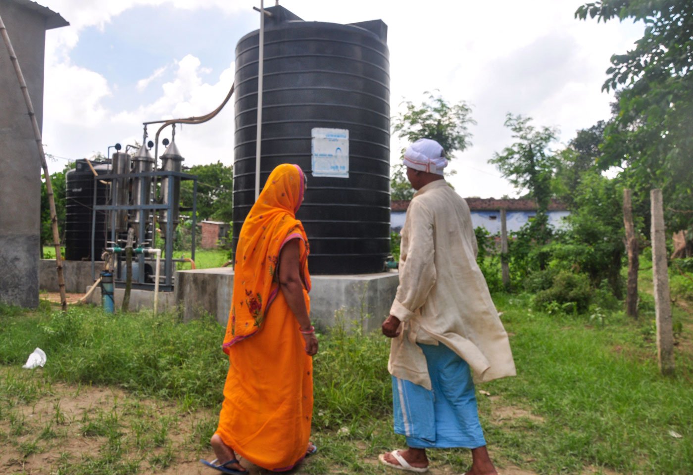 Ramuni Devi and Umashankar Yadav at the filtration plant on their farmland; shops selling RO-purified water have also sprung up