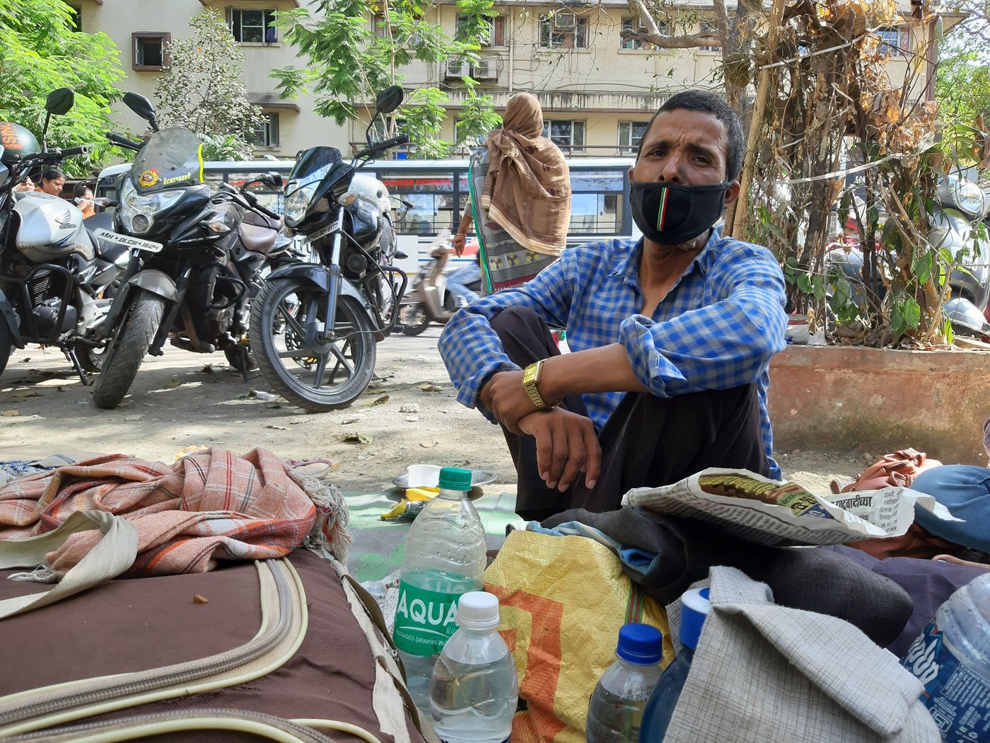 Left: Jamil Khan, who has oral cancer, moved to a distant relative's home in Nalasopara with his mother and siblings after the lockdown came into effect. They had lived on the street for seven months prior to that. Right: Cancer patients live out in the open opposite the hospital. With little food, water and sanitation, they are at a greater risk of contracting Covid-19