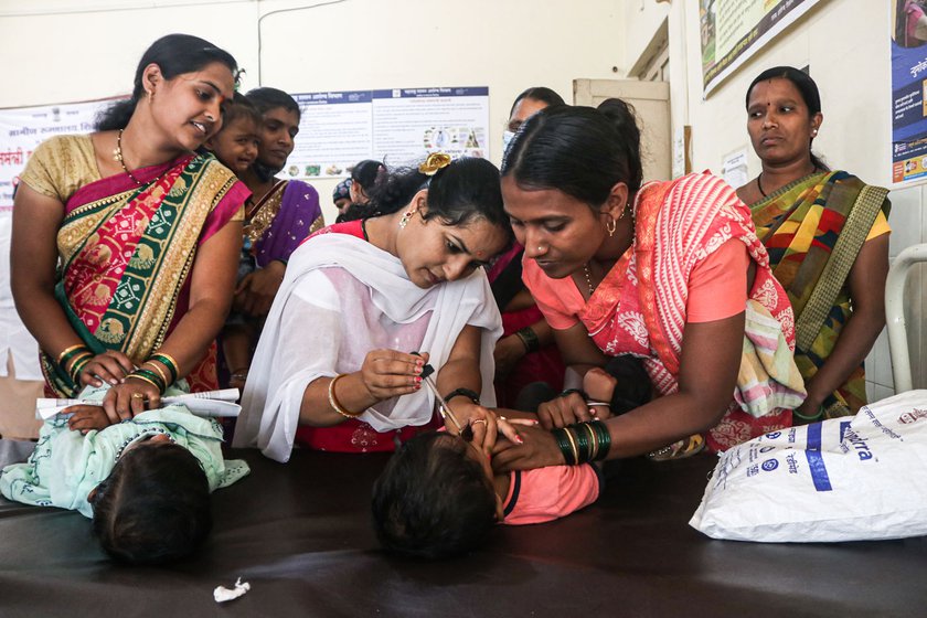 ASHA worker Netradipa Patil administering oral vaccine to a child at the Rural Hospital, Shirol