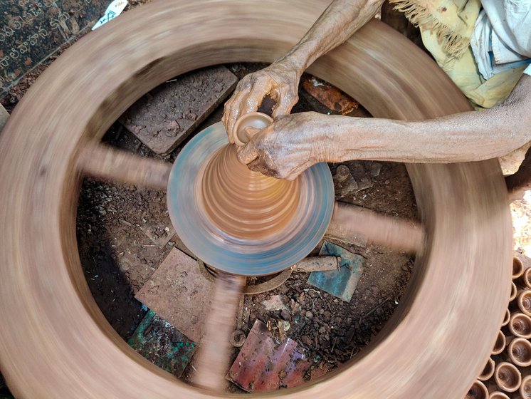 Left: The wooden potters' wheel is heavy for the 92-year-old potter to spin, so he uses a long wooden stick (right) to turn the wheel and maintain momentum