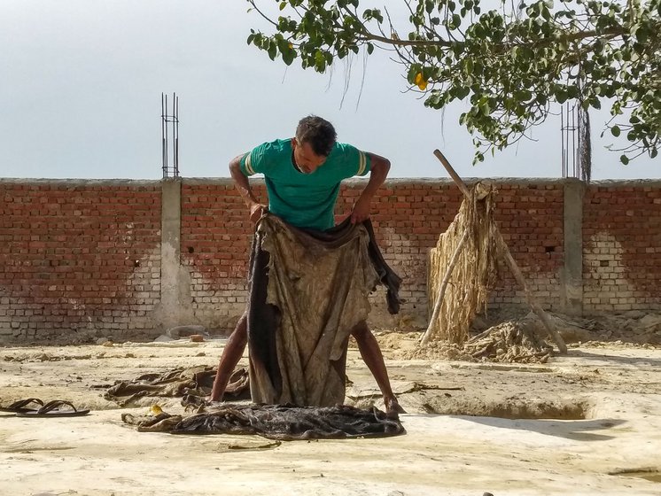 Left: A leather-worker washes and removes dirt, dust and soil from the raw hide. Once clean and rehydrated, hides are soaked in a water pit with lime and sodium sulphide. 'The hides have to be vertically rotated, swirled, taken out and put back into the pit so that the mixture gets equally applied to all parts,' Bharat explains.