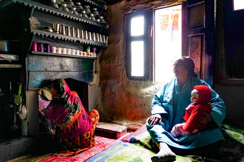 Left: Zooni Begum with her grandson at her home in Baduab.