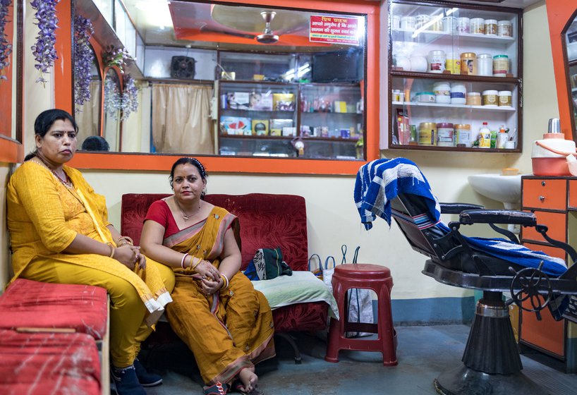 Tunni and Pramila relaxing while waiting for their next customer