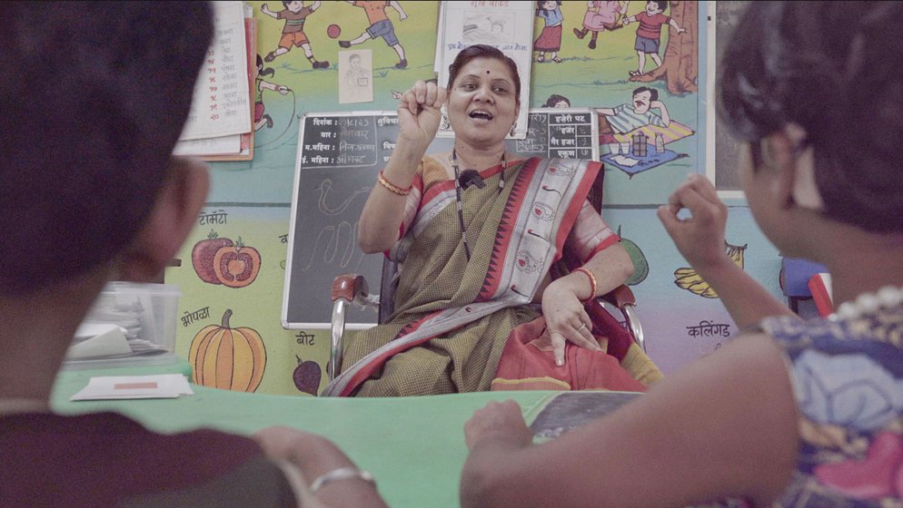 At the Dhayari School for the Hearing Impaired, Aditi Sathe (left) using picture cards . Sunita Zine (right) is the hostel superintendent and is teaching colours and Marathi alphabets to the youngest students