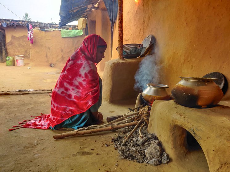 Shamsunisa cooking in the house. She says her husband, Farooq, could not spend much time with the baby