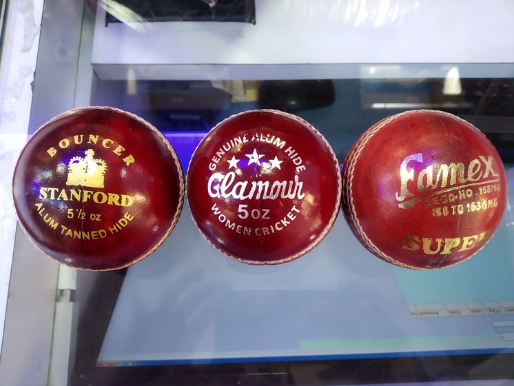Right: Gold and silver foil-stamped cricket balls at a sports goods retail shop in Dhobi Talao, Mumbai. These have been made in different ball-making units in Meerut