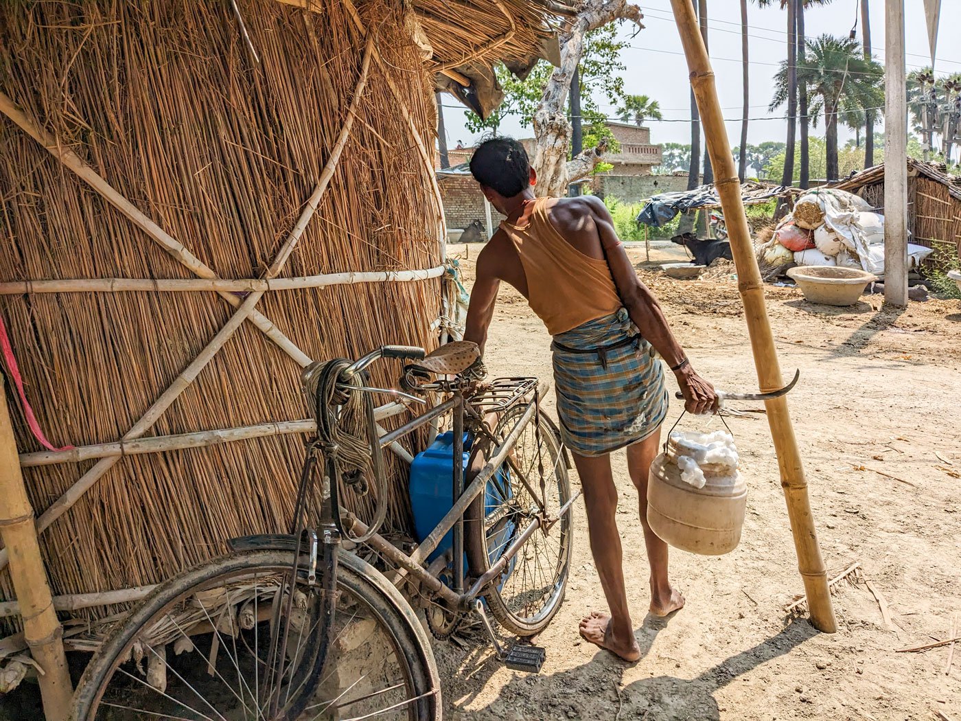 Ajay will transfer the fresh toddy which has a lather of white foam to a bigger plastic jar fixed to his bicycle.