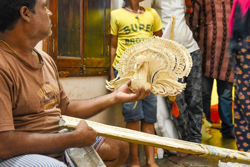 Upendra showing a peacock made from sholapith , usually used for decoration in Puri hotels