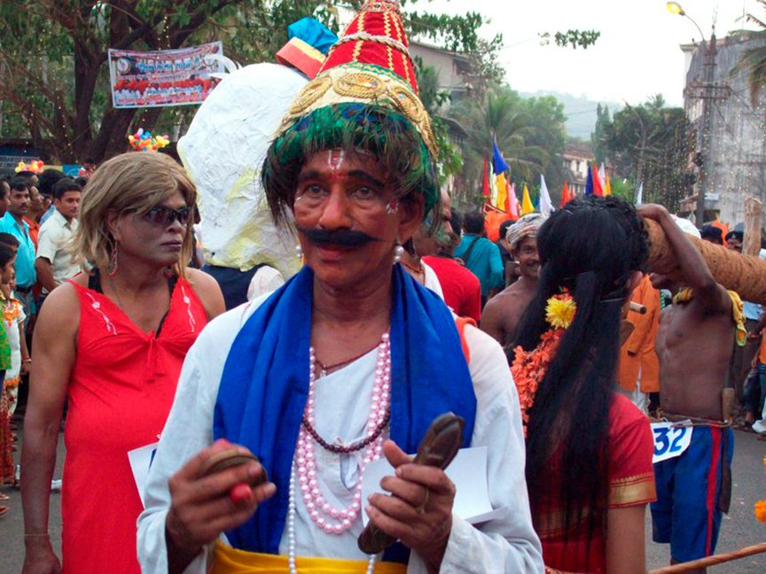A man dressed in a costume poses