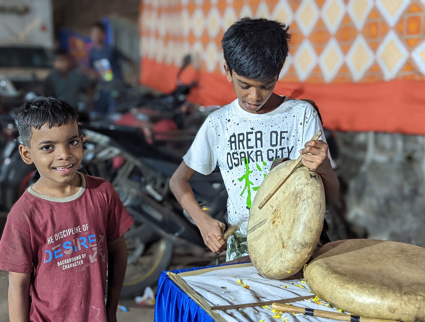 Aran (white tee-shirt) plays the parai (percussion) instrument for the rally