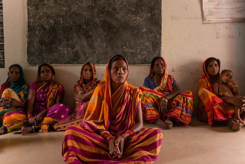 Geeta Malik (in the foreground) and other mothers speak about the dangers their children must face while travelling to reach school in Chakua.