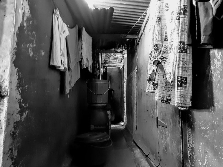 The teenager's immediate world: the streets of the city, and the narrow passageway in the brothel building where he sleeps. In future, Vikram (left, with a friend) hopes to help sex workers who want to leave Kamathipura

