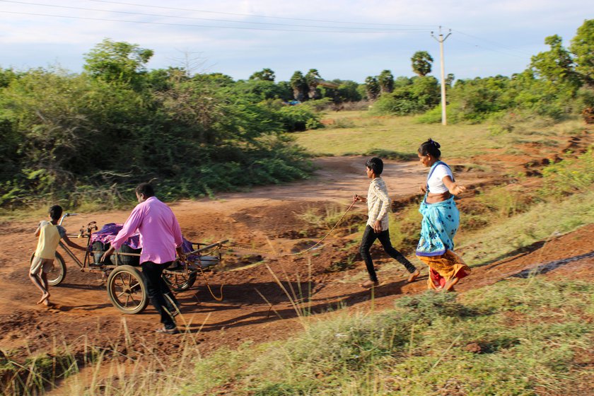 take turns fetching drinking water in a wheel barrow (right) every morning