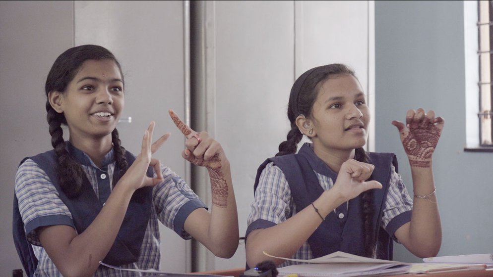 Mohan Kanekar (left) is an experienced special teacher at Dhayari School for the Hearing Impaired. He is teaching Marathi words to Class 4. ‘You have to be good at drawing if you want to teach these students,’ he says. A group of girls (right) in his class following the signs and speech of their teacher