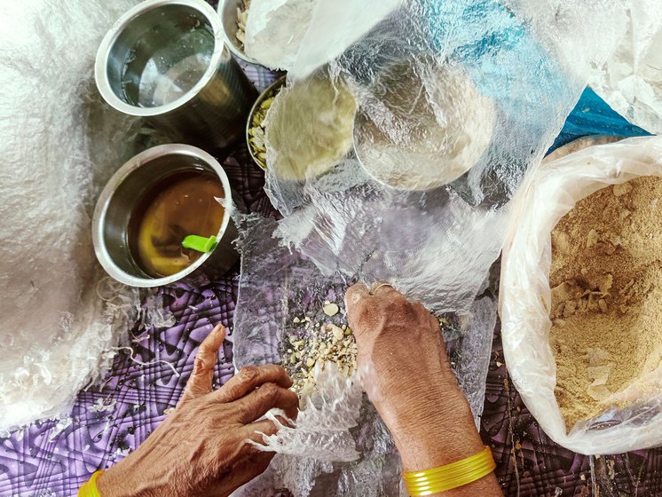 Shyamala folds a film of rice paper with dry fruits, jaggery powder and more to make a poothareku . First she gently flattens the film, spreads a few drops of sugar syrup and a then generous amount of ghee after which she adds dry fruits