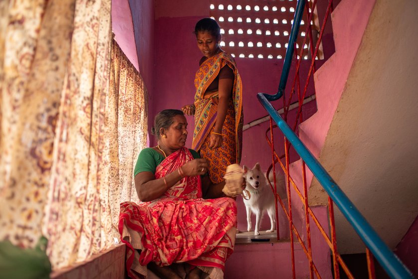 Right: Kavitha and Seetha love dogs. Here, they are pictured talking to their dog