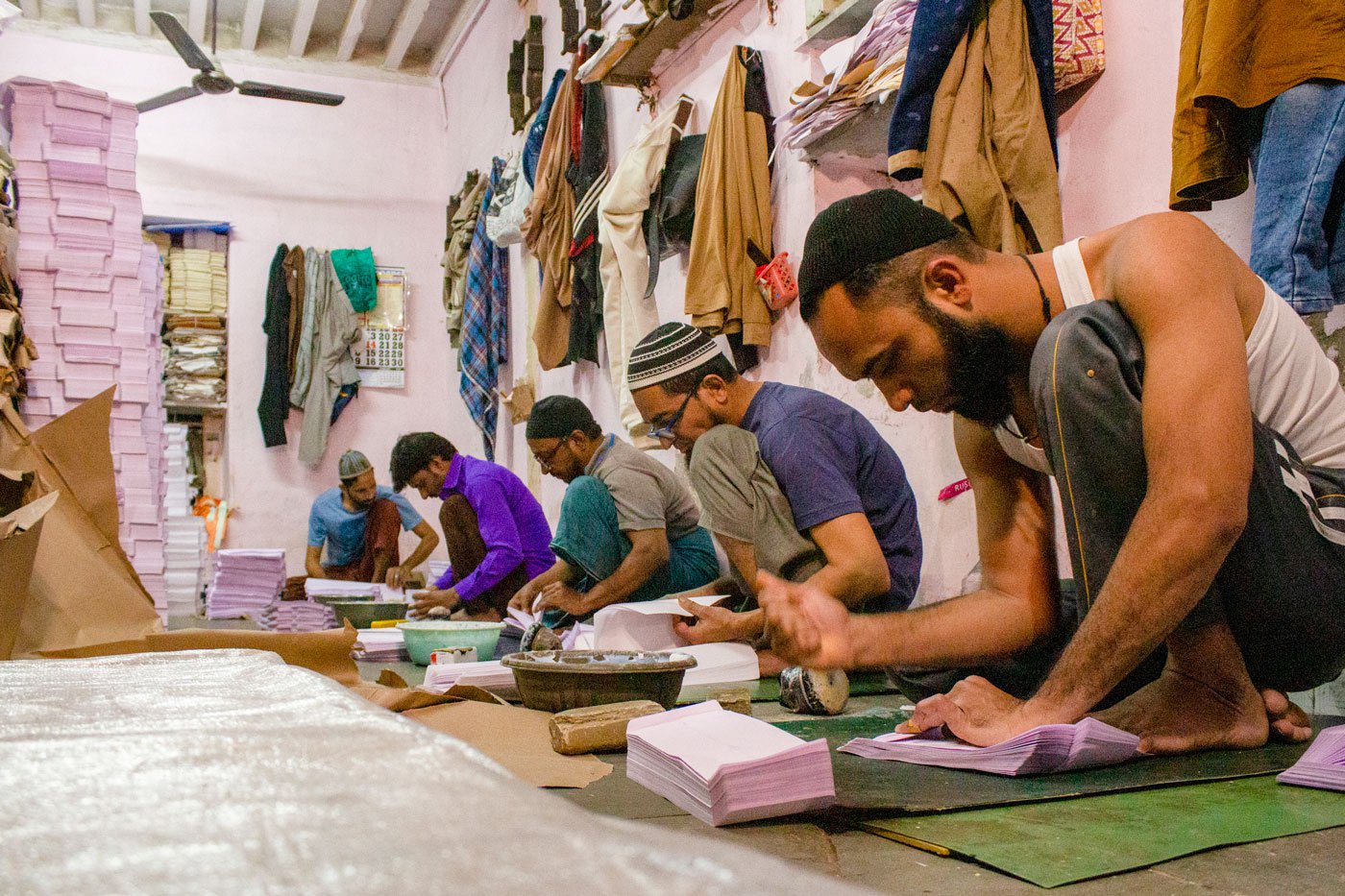 Artisans at Om Traders counting the sheets and getting piles of 100 each ready to be folded
