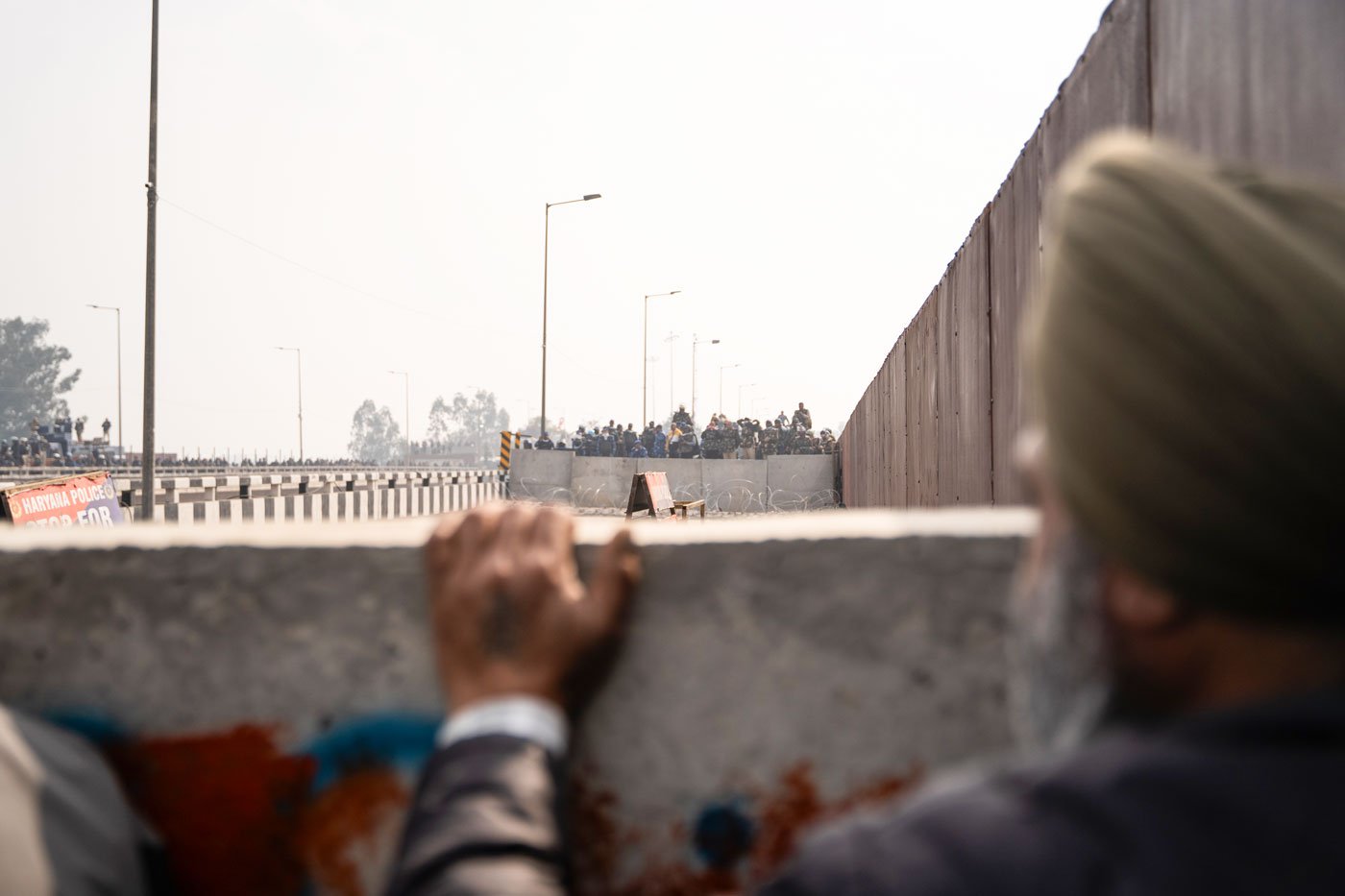 At the Shambhu border, they were met with paramilitary, RAF, and police officers. Concrete walls had been set up along with nails laid on the road