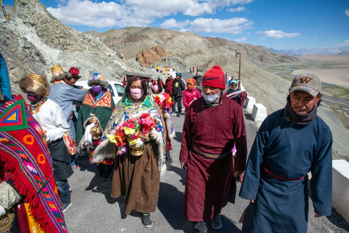 The procession of devotees from the six hamlets walk through the corridor into the monastery