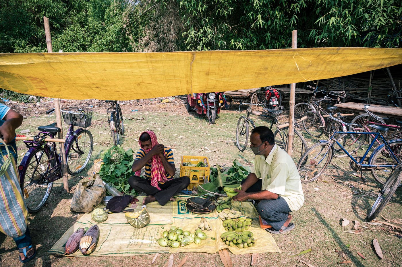 Many are using improvised masks, as is 37-year-old Bablu Shaikh, a farmer and part-time vegetable seller, who is using a gamchha.