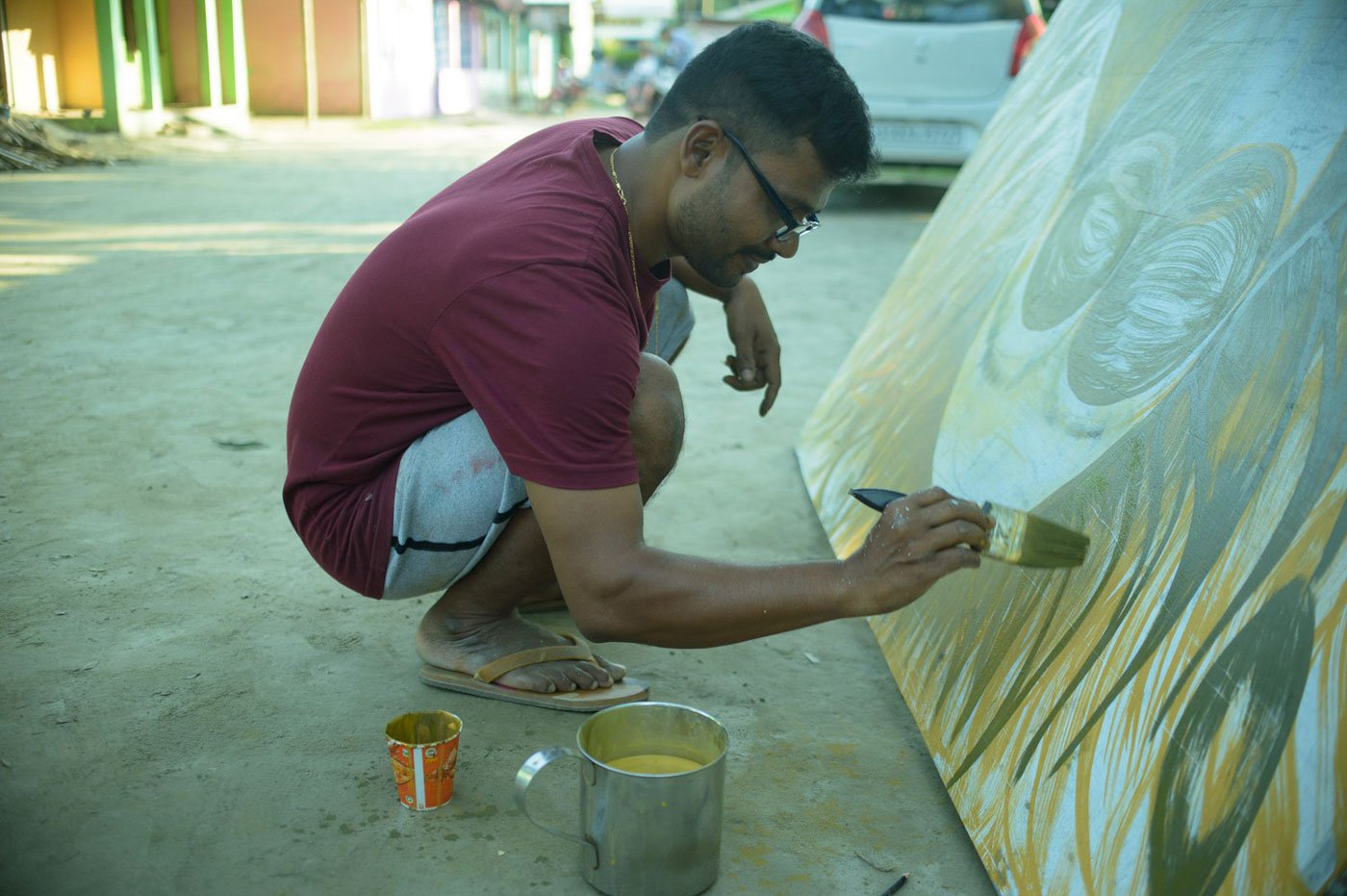 For the last 11 years, Bastav Saikia has been travelling to Majuli from Nagaon district to work on sets for the festival. Here, he is painting the backdrop for Kansa's throne to be used at the Garamur performance