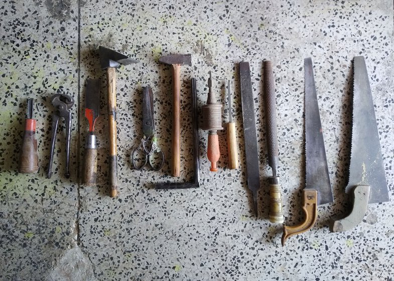 The tools of the craft from left to right: nola , jamura (plier), chorsi (chisel), bhasola (chipping hammer), scissors, hammer, three hole cleaners, two rettis ( flat and round hand files) and two aaris (hand saws)