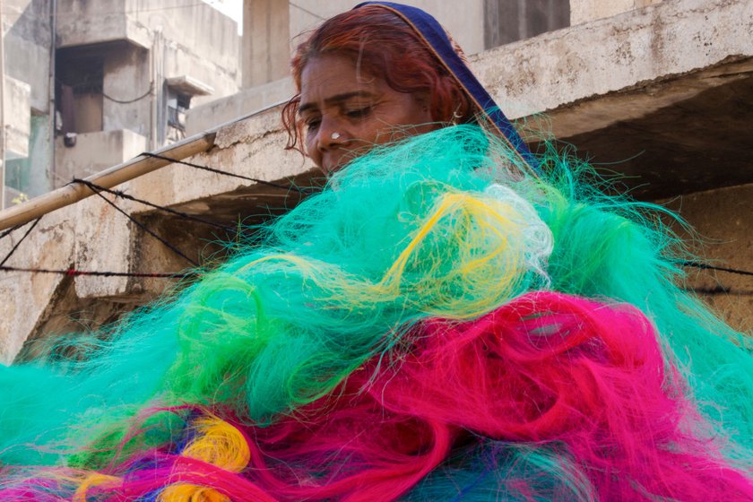 The Rajbhoi women buy a variety of discarded resam (synthetic) fibre from textile factories in Surat district and carry it back to Ahmedabad via train. The coloured fibre is cheaper and costs around Rs. 15 to 27 a kilo
