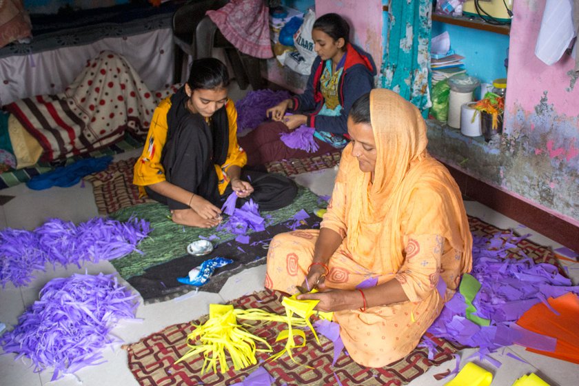Firdos Banu (in orange salwar kameez), her daughters Mahera (left) and Dilshad making the kite tails