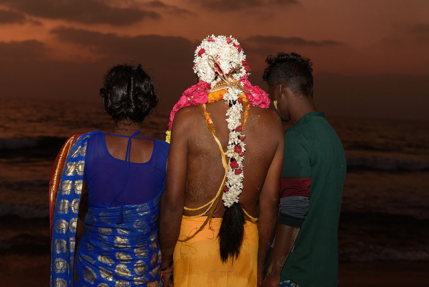 Men believed to be possessed by the goddess dress up in sarees and adorn their heads with flowers