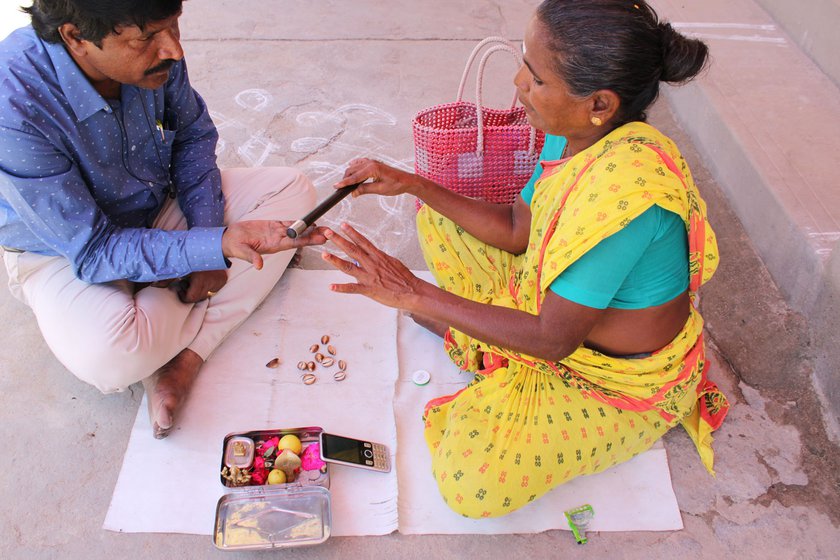 A palm-reader in front of the Murugan temple in Madurai .