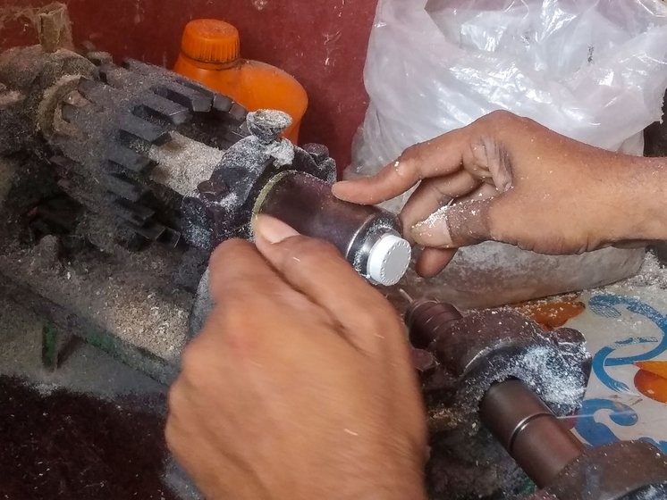 Left: The drilling machine is the only hand -operated machine in the entire process. Sanjib uses it to make 16 holes into the readymade cork bases.