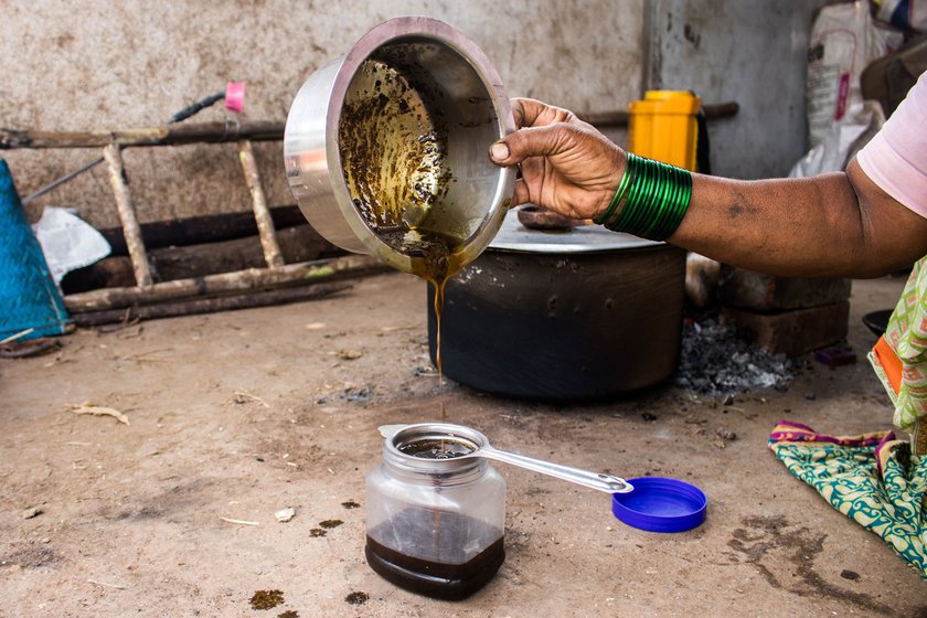 Kusum filters the castor oil using a tea strainer. 'For the past four years, no one has come to take the oil,' she says