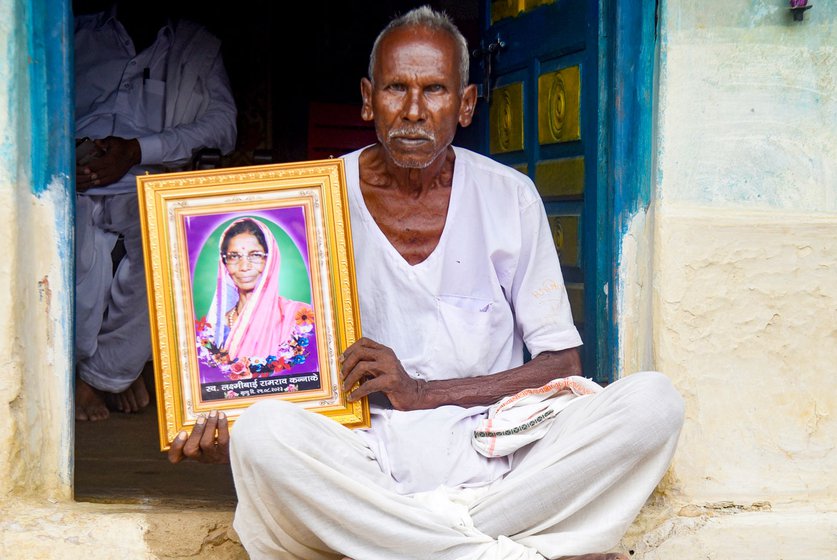 Farmer Ramram Kannane (left) with the framed photo of his late wife Laxmibai who was killed in a tiger attack in Tekadi village in August 25, 2023. Tekadi is on the fringe of TATR in Bhadrawati tehsil , close to the famous Moharli range