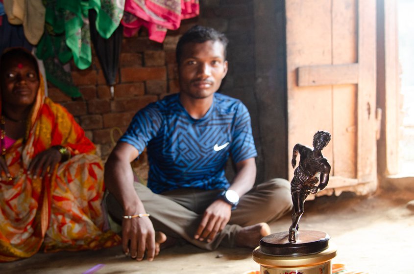 Left: Chhagan participates in big and small marathons at city, taluka, state and country level. His prize money supports the family. Pointing at his trophies his mother Bhagirata says, 'this is more precious than any gold.'