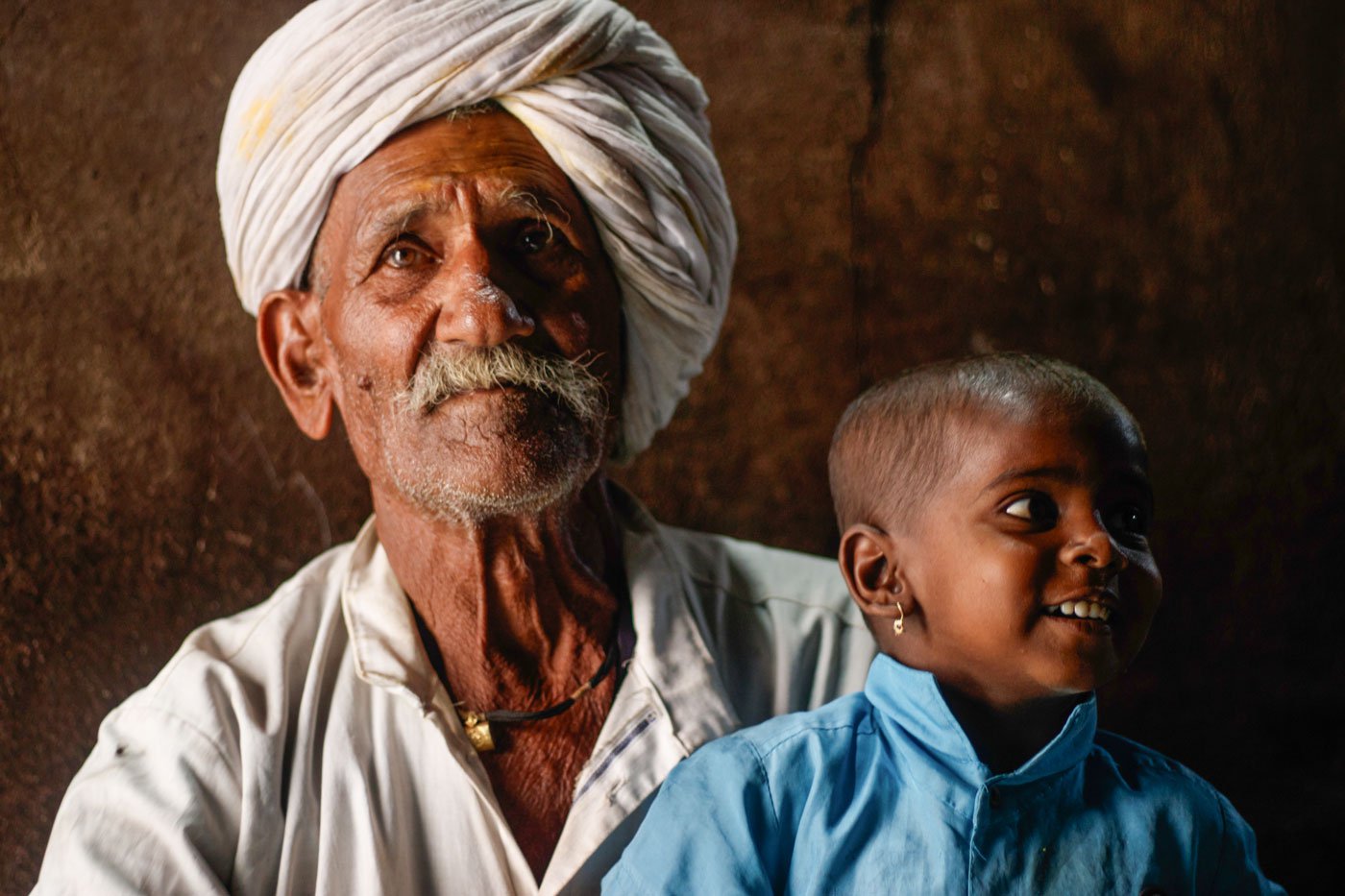 Right: Siddu spends time with his grandson in their house in Karadaga village, Belagavi.