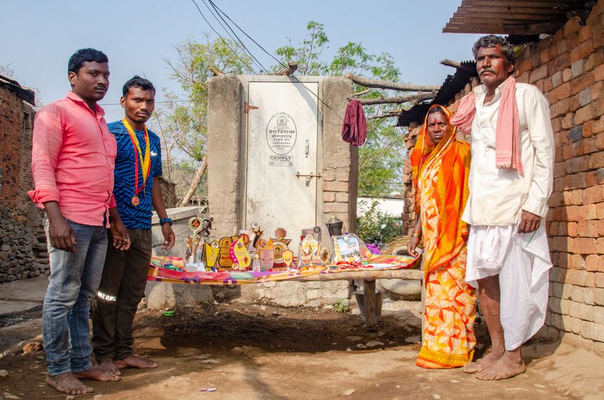 Right: Chhagan with his elder brother Balu (pink shirt) on the left and Chhagan's mother Bhagirata and father Maruti on the right