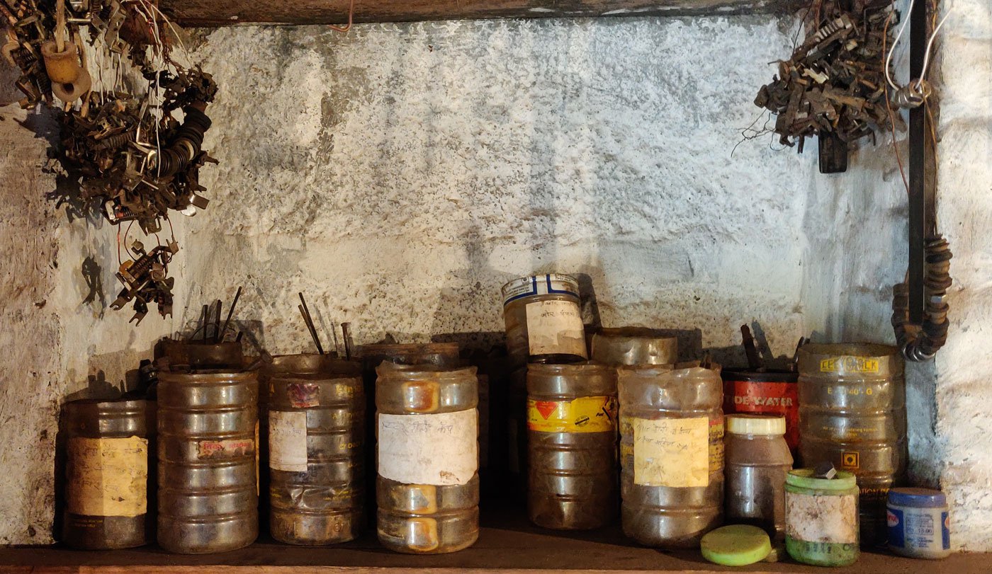 Bapu stores the various materials used for his rewinding work in meticulously labelled plastic jars