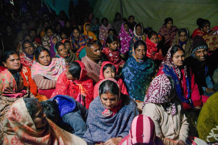 A packed crowd of close to 400 people wait for the performance to begin