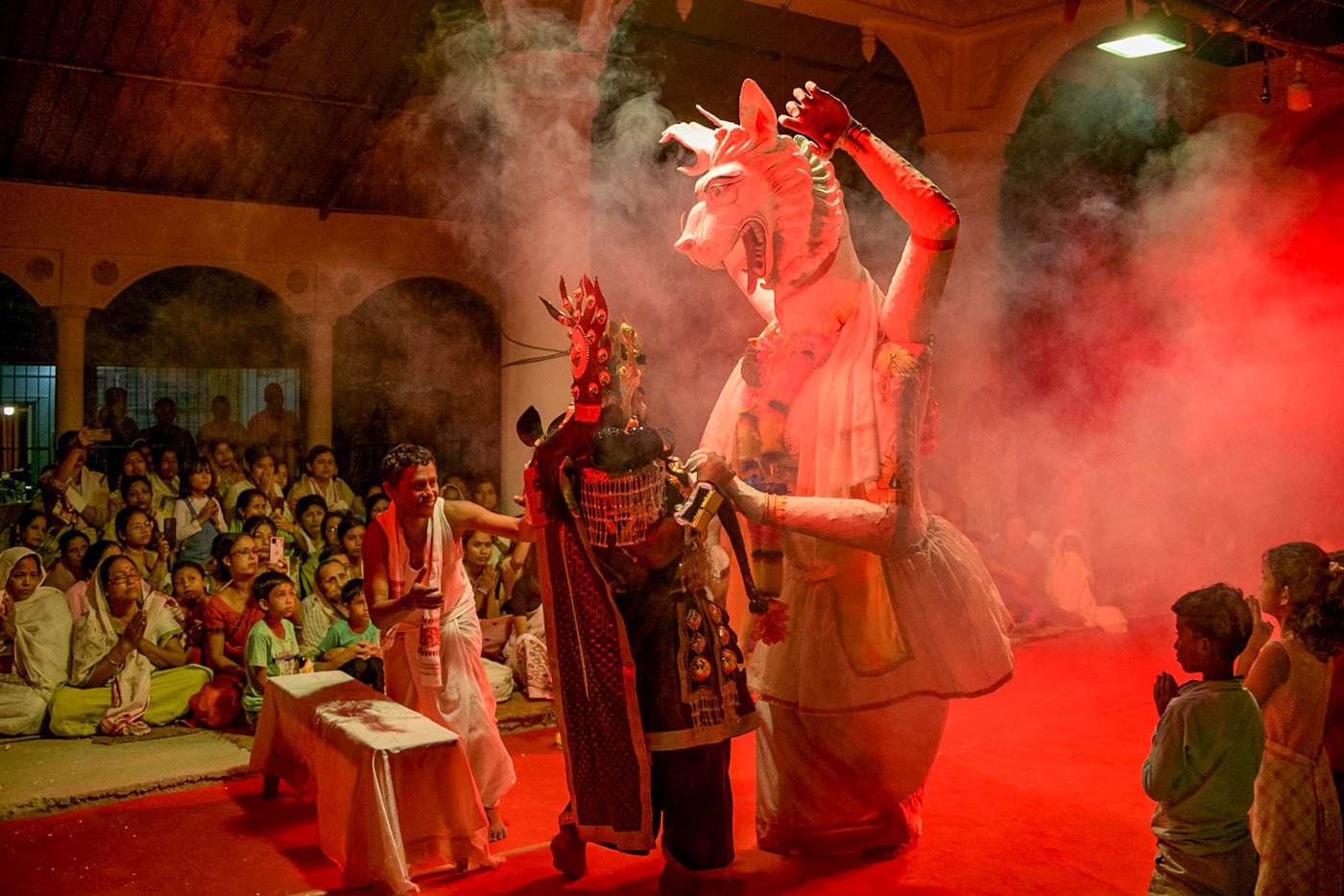 In a scene from the Nri Simha Jatra drama, Dutta (left) helps the actor wearing the mask of the half lion, half human Nri Simha.