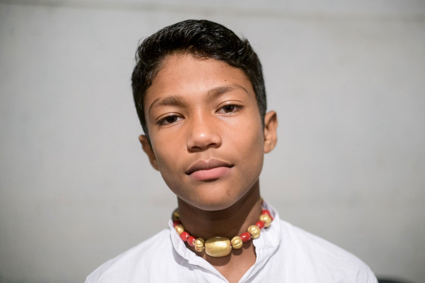 Thirteen-year-old bayan Jyotishman Dutta waits to perform during Raas Mahotsav